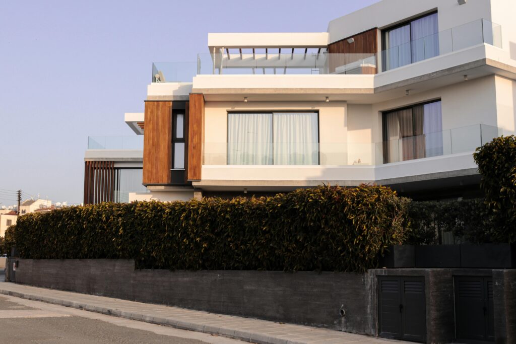 A contemporary luxury villa featuring minimalistic architecture and lush greenery.